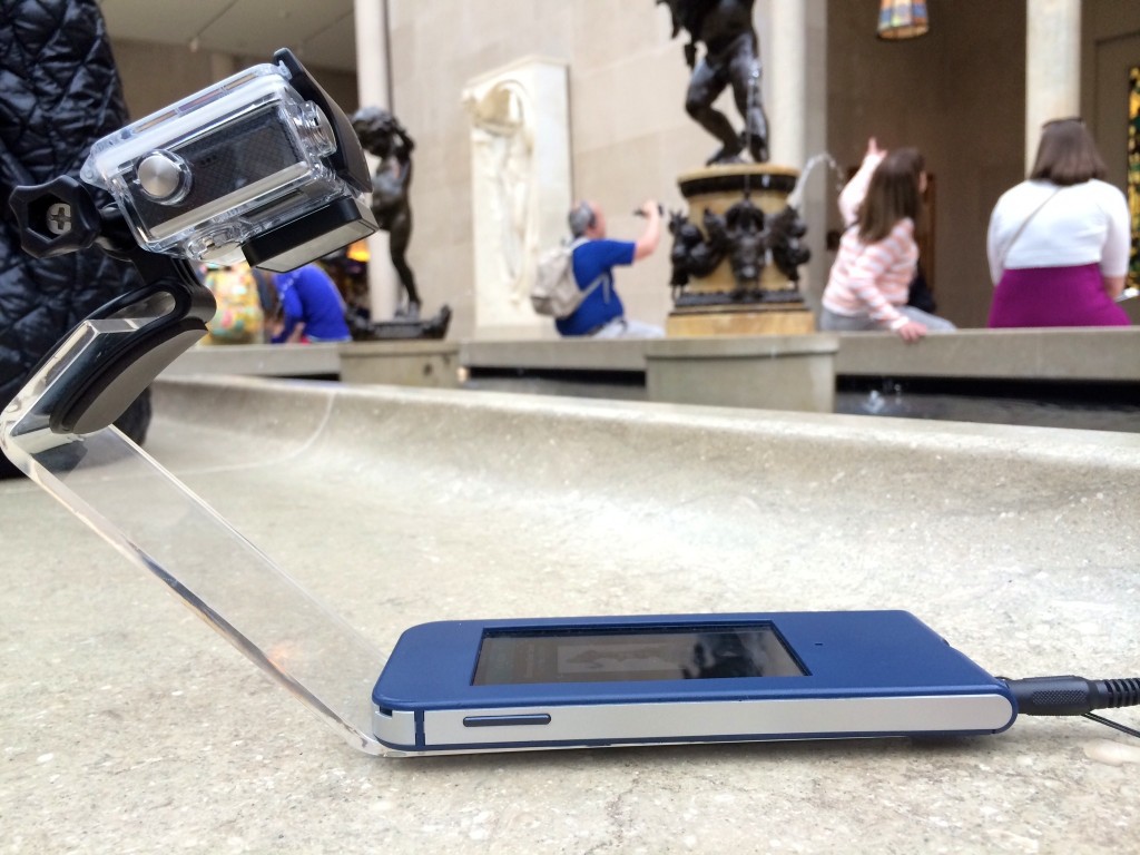 Figure 3. In-gallery usability testing rig: GoPro® video camera and audio guide player mounted to an acrylic sled